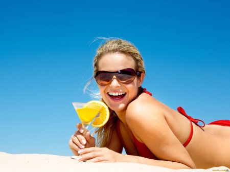 Девушка с коктейлем на пляже