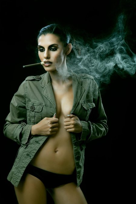 Девушка курит сигару