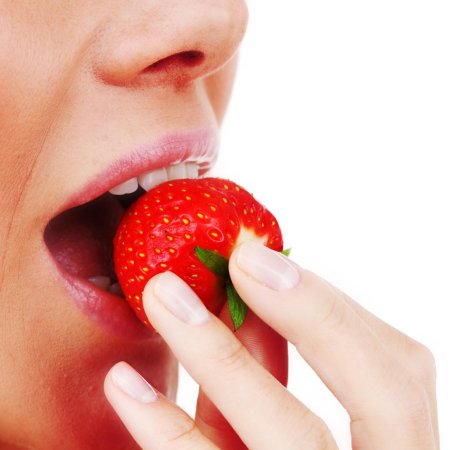 Женщина ест клубнику