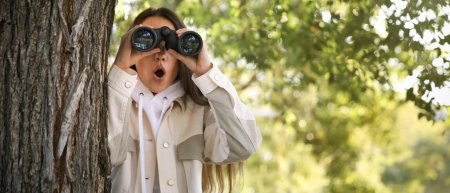 Женщина смотрит в бинокль