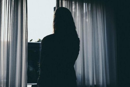 Девушка у окна со спины