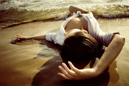 Девушка лежит на песке