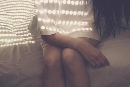 Брюнетка со спины на кровати