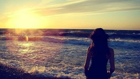 Брюнетка на море со спины